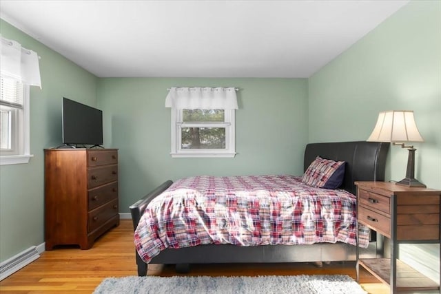 bedroom featuring baseboard heating and light wood-type flooring