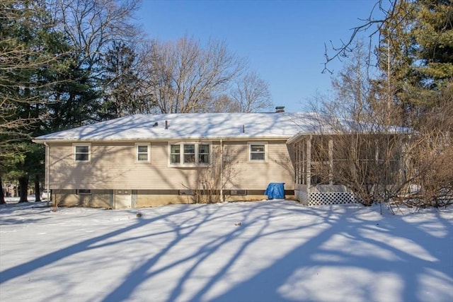 view of snow covered back of property