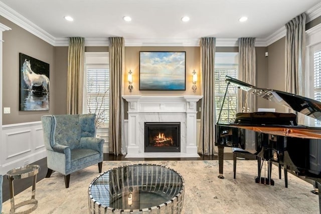 sitting room featuring crown molding, a fireplace, a healthy amount of sunlight, and hardwood / wood-style flooring