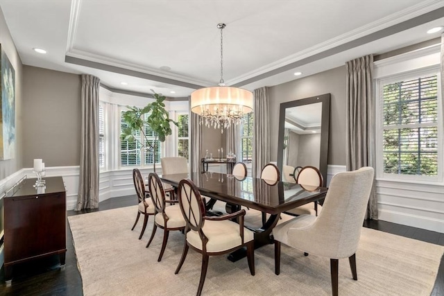 dining room with hardwood / wood-style flooring, ornamental molding, a wealth of natural light, and a tray ceiling