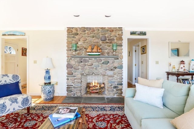12 Taunton Ave, Marion, MA 02738 - living room featuring crown molding, wood finished floors, and a stone fireplace