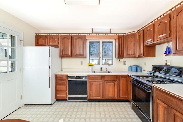 12 Taunton Ave, Marion, MA 02738 - kitchen with black appliances, a sink, light countertops, light flooring, and plenty of natural light