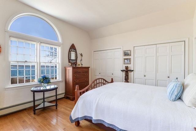 12 Taunton Ave, Marion, MA 02738 - bedroom featuring a baseboard radiator, multiple closets, wood finished floors, and vaulted ceiling