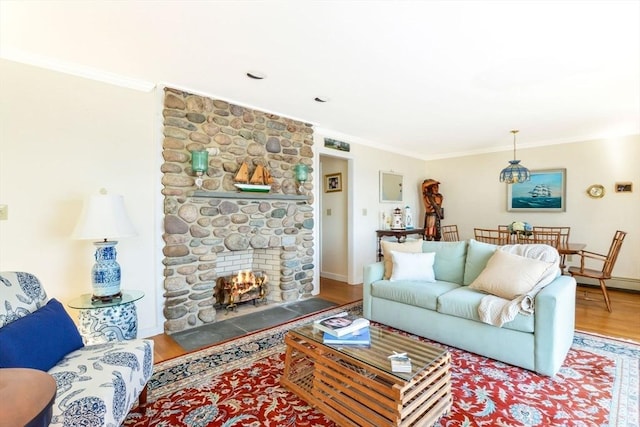 12 Taunton Ave, Marion, MA 02738 - living area with wood finished floors, crown molding, a stone fireplace, and baseboards