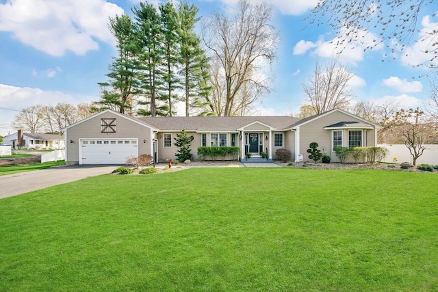 ranch-style house featuring an attached garage, driveway, and a front yard