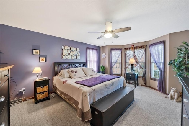 carpeted bedroom with a ceiling fan and baseboards
