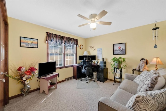 office space with baseboards, a ceiling fan, and light carpet