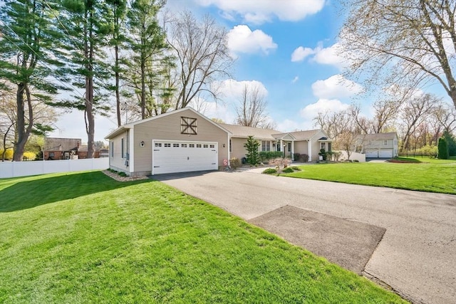 single story home with fence, an attached garage, driveway, and a front lawn
