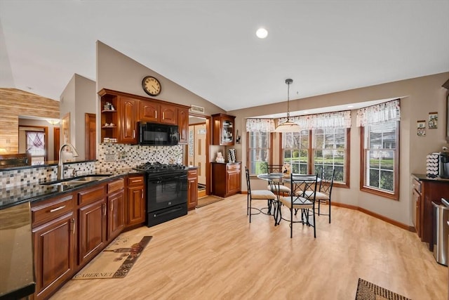 kitchen featuring open shelves, vaulted ceiling, a sink, black appliances, and light wood-style floors
