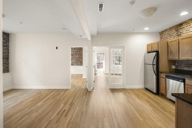 kitchen featuring baseboards, brown cabinetry, light wood finished floors, dark countertops, and stainless steel appliances