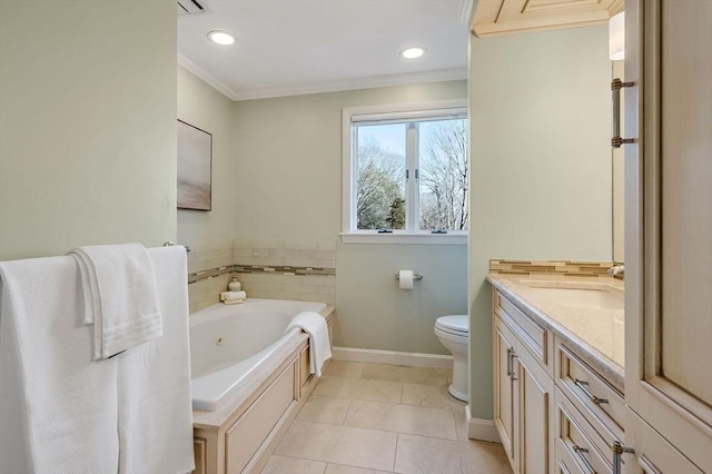 bathroom with crown molding, toilet, vanity, a whirlpool tub, and baseboards