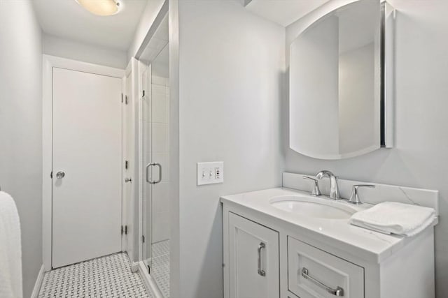 bathroom featuring a shower stall and vanity