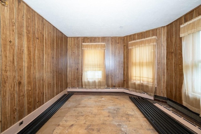 127 Cliff St, Southbridge, MA 01550 - empty room featuring wooden walls, a baseboard heating unit, and wood-type flooring