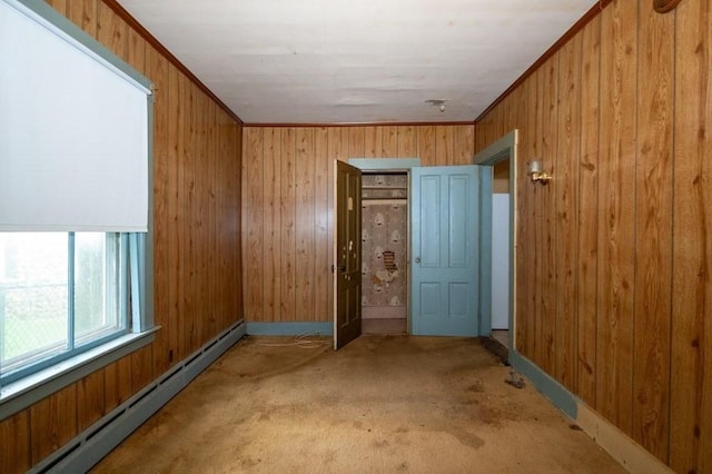 127 Cliff St, Southbridge, MA 01550 - carpeted spare room with a baseboard radiator, wooden walls, and baseboards