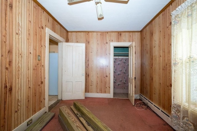 127 Cliff St, Southbridge, MA 01550 - unfurnished bedroom with wooden walls, carpet flooring, a ceiling fan, baseboards, and a baseboard heating unit