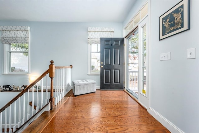 entryway featuring a wealth of natural light, baseboards, and wood finished floors