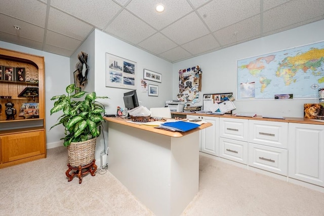 office space with a drop ceiling and light colored carpet