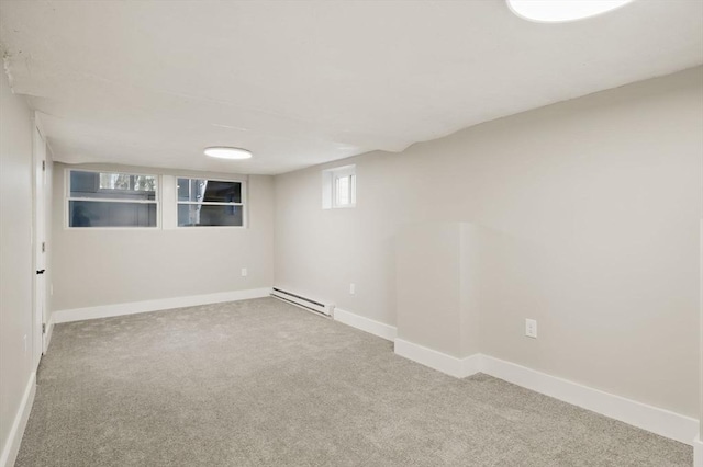 basement with baseboards, carpet flooring, and baseboard heating