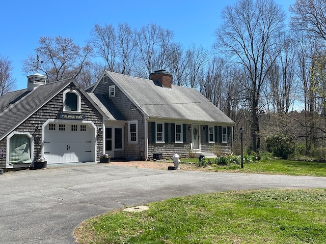 view of front of property with a garage and a front lawn