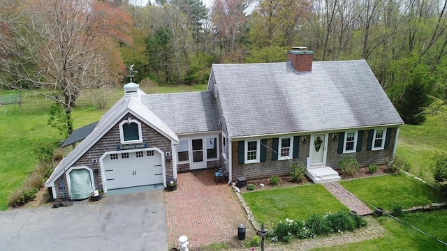 view of front facade with a garage and a front lawn