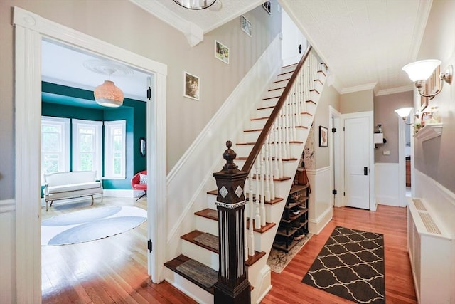 253 Front St, Weymouth, MA 02188 - stairway featuring ornamental molding, wood finished floors, and wainscoting