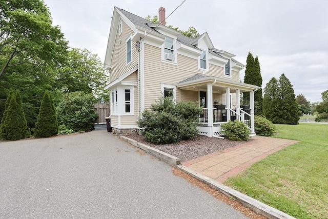 253 Front St, Weymouth, MA 02188 - view of front of house featuring a porch, a front yard, a chimney, cooling unit, and roof with shingles