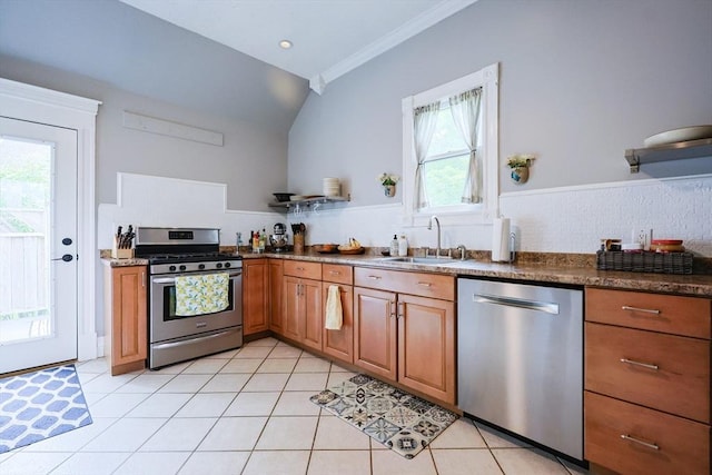 253 Front St, Weymouth, MA 02188 - kitchen featuring appliances with stainless steel finishes, a sink, brown cabinetry, lofted ceiling, and ornamental molding