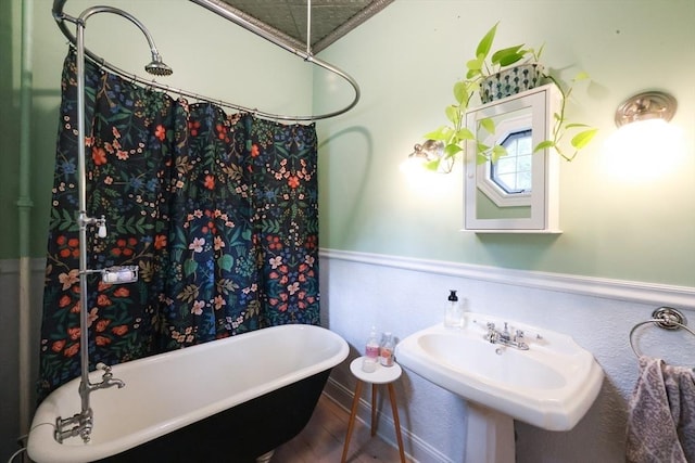253 Front St, Weymouth, MA 02188 - bathroom with a soaking tub, wood finished floors, and a sink
