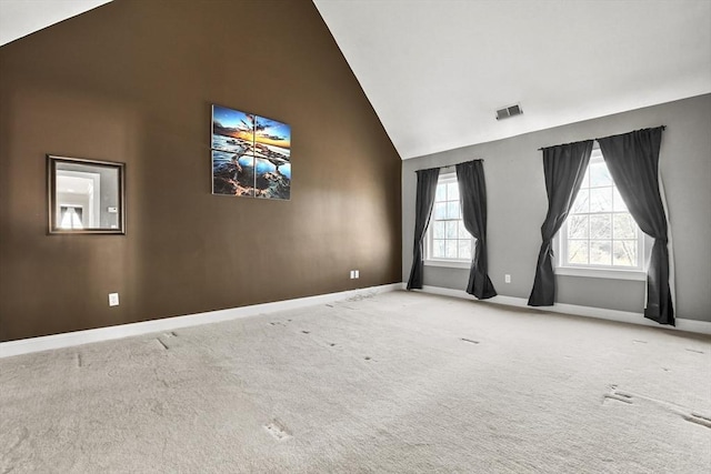 empty room with visible vents, high vaulted ceiling, baseboards, and carpet floors