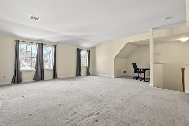 unfurnished living room featuring visible vents, baseboards, lofted ceiling, and carpet floors