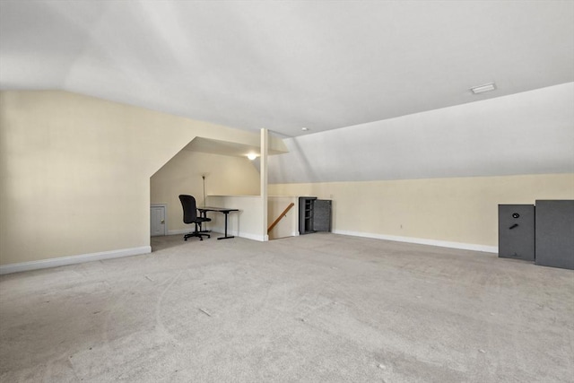 additional living space with baseboards, carpet, and vaulted ceiling