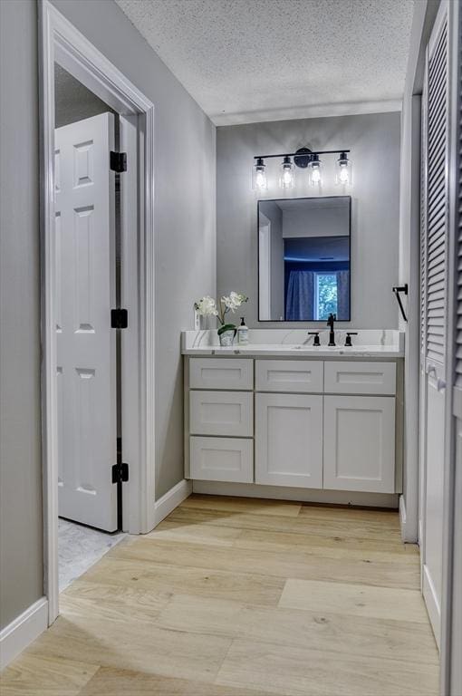 32 Sandy Reach Unit 32, Falmouth, MA 02536 - bathroom featuring a textured ceiling, vanity, and wood finished floors