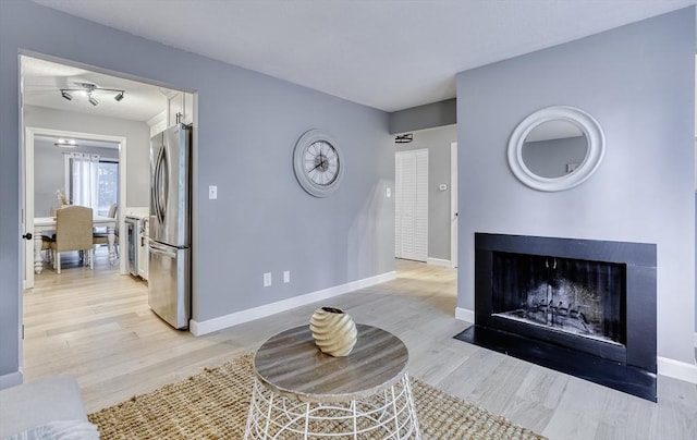 32 Sandy Reach Unit 32, Falmouth, MA 02536 - living room with a fireplace with flush hearth, light wood-type flooring, and baseboards