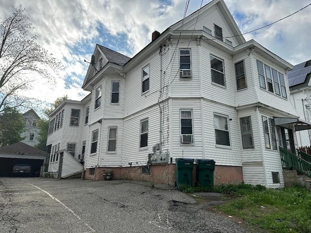 97-99 Gates St, Lowell, MA 01851 - view of side of home featuring a chimney and cooling unit
