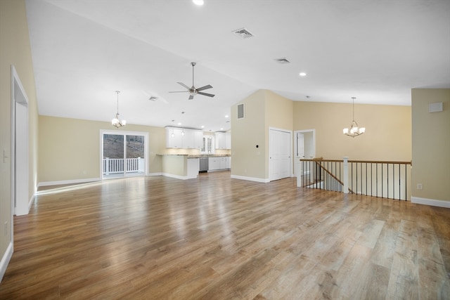 unfurnished living room with light hardwood / wood-style flooring, ceiling fan with notable chandelier, and high vaulted ceiling