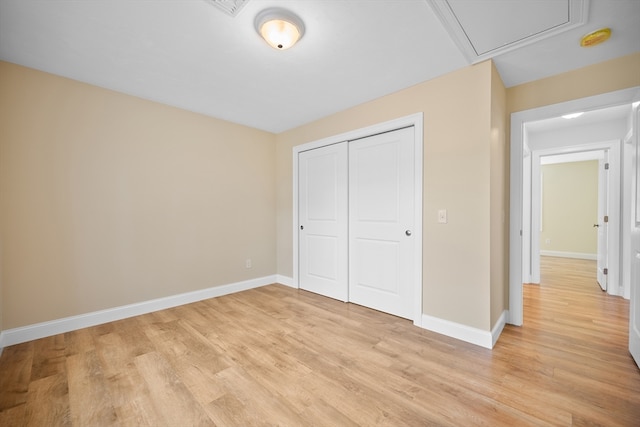 unfurnished bedroom featuring a closet and light hardwood / wood-style flooring