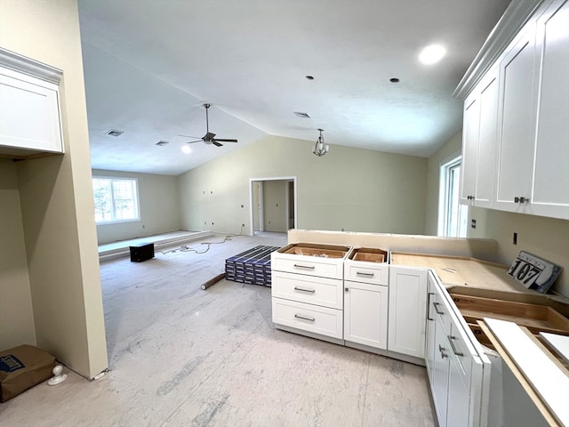 kitchen with white cabinetry, ceiling fan, and lofted ceiling