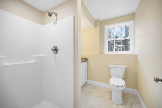 bathroom featuring walk in shower, vanity, and toilet