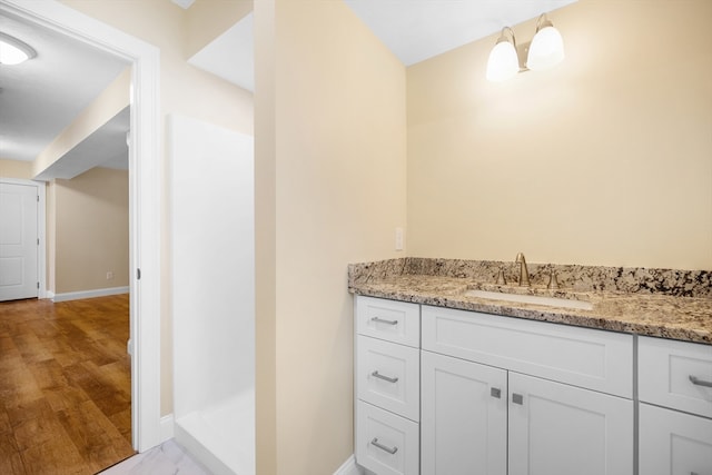 bathroom with hardwood / wood-style floors and vanity