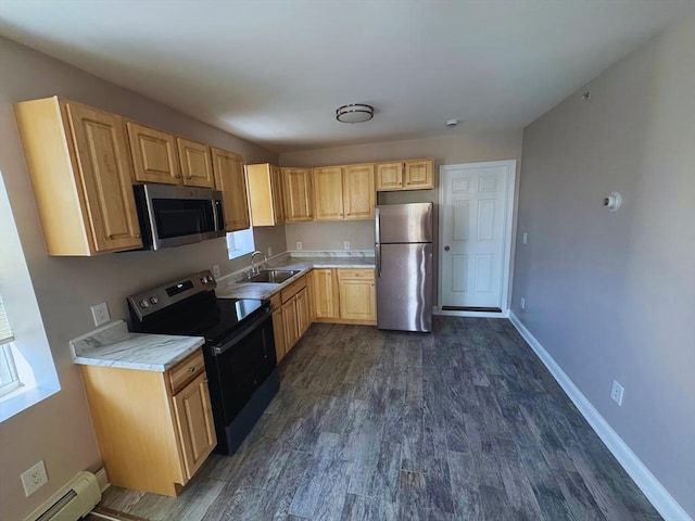 kitchen with sink, dark wood-type flooring, stainless steel appliances, and a baseboard heating unit