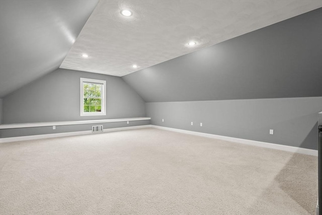 bonus room with lofted ceiling, baseboards, recessed lighting, and carpet floors