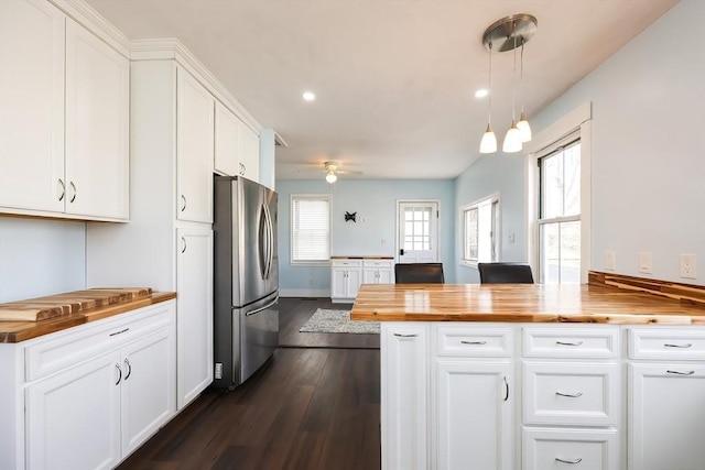 kitchen featuring ceiling fan, freestanding refrigerator, white cabinets, wood counters, and dark wood-style flooring