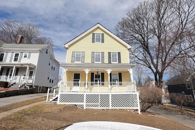 view of front facade featuring a porch and driveway