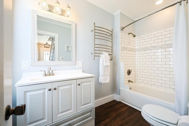 bathroom with shower / bath combo with shower curtain, toilet, wood finished floors, baseboards, and vanity