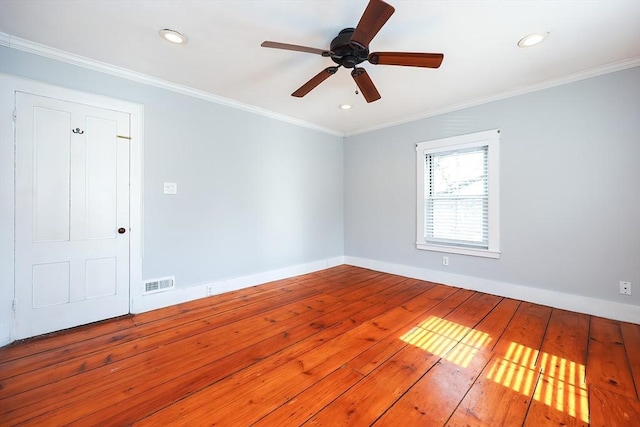 unfurnished room featuring hardwood / wood-style floors, baseboards, visible vents, recessed lighting, and crown molding