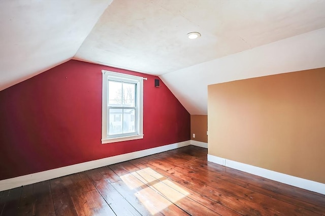 bonus room with lofted ceiling, baseboards, and wood-type flooring