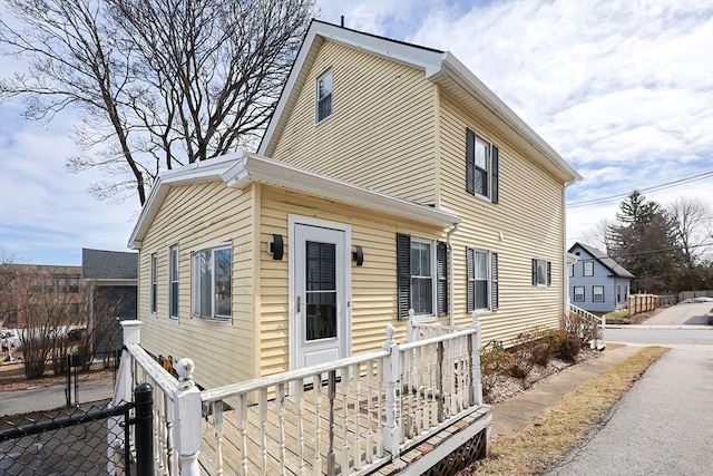 view of home's exterior with fence