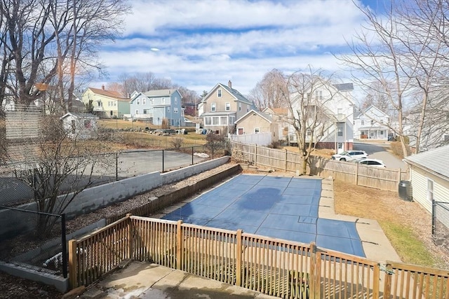 view of pool with a fenced in pool, a residential view, a fenced backyard, and a patio area