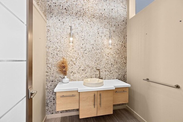 bathroom with hardwood / wood-style flooring and vanity