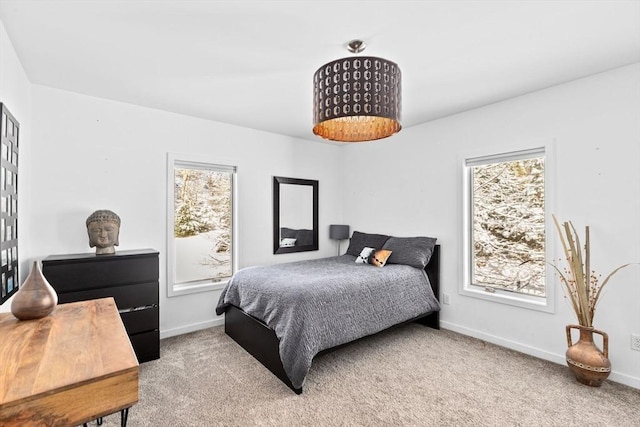 carpeted bedroom featuring multiple windows